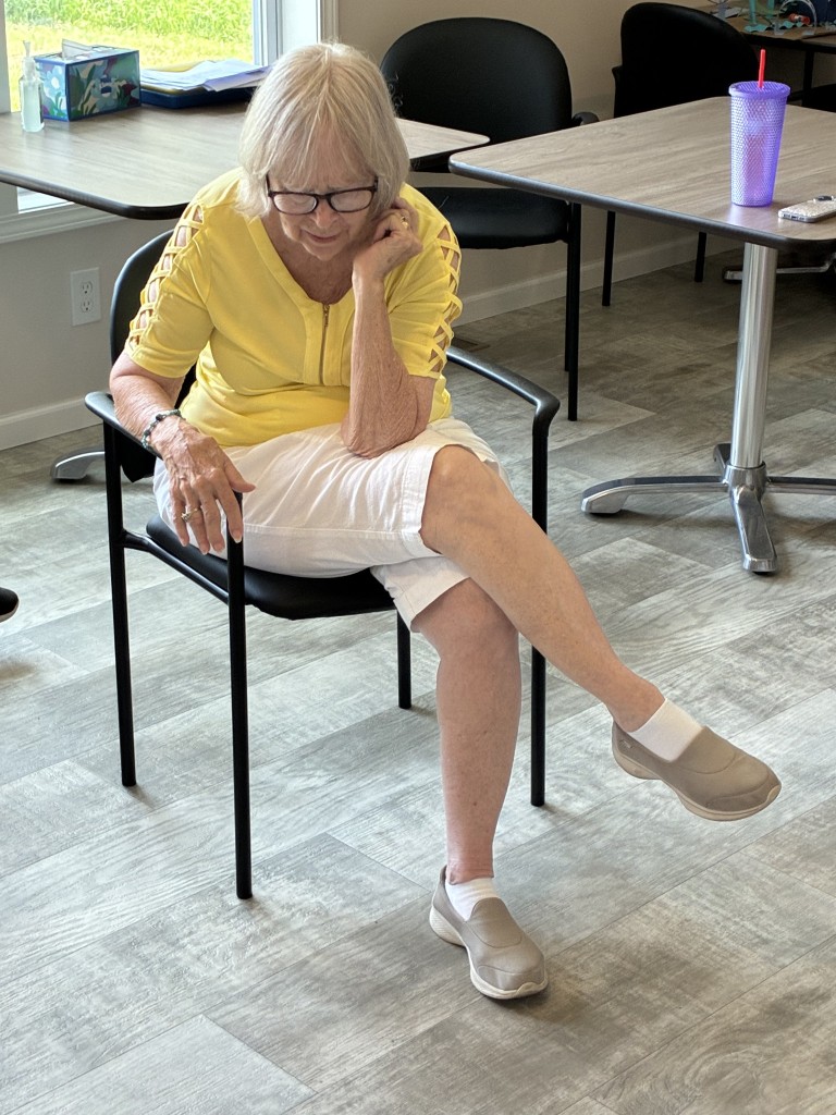Nonprofit Spotlight: Wilbur and Charlotte Courter Memory Center 4 An older woman bends her body as she sits in a chair.